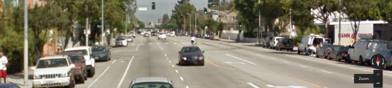 Google Street View of 28th and Hoover, a doglegged intersection and two cyclists riding across a crosswalk